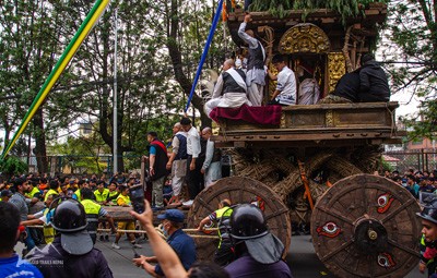 Close-up of the massive wooden wheels and intricate base of the Seto Machindranath chariot during the Rath Jatra in Kathmandu, Nepal.